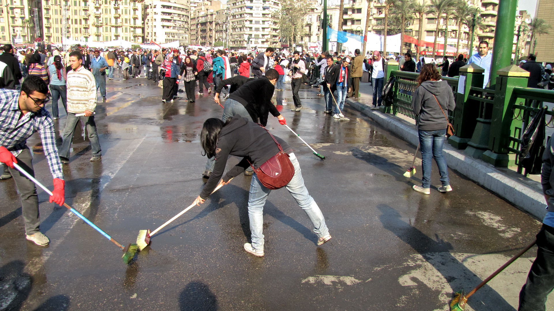 Protesters and volunteers sweep Tahrir Square, during the Egyptian Revolution of 2011, a day after Hosni Mubarak's resignation as president, in a gesture of a new beginning.